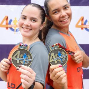 Two DP World employees display their medals after completing the 40th edition of the 10KM Tribuna FM Race in Santos, Brazil.