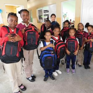 Group of young school children shown with their new HanesBrands backpacks for Back to School.