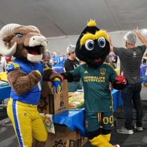 LA Galaxy's mascot Cozmo joins LA Ram's mascot Rampage at the 9/11 Day LA Meal Pack.