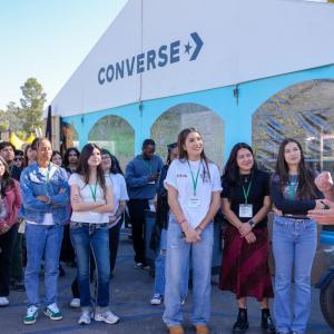 Group of students listening to speaker outside