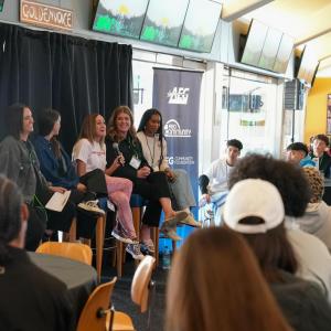 Speakers sitting in front of audience 