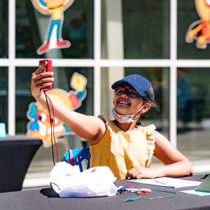 Girl holding up science project
