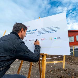 Man signing a large placard