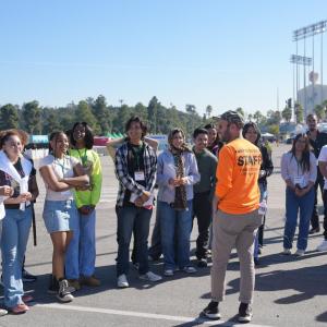 Group of students listening to a speaker outside