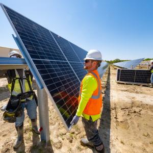 two men working on solar panels