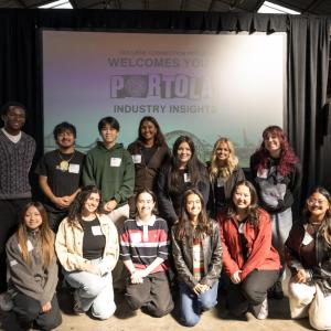 College students and program participants pose together in front of a screen displaying “Portola Industry Insights” during the College Connection Program.