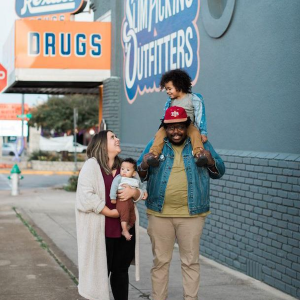 Jahmicah and Heather Dawes with their two children in front of Slim Pickins Outfitters.