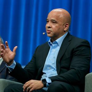 Dan Purefoy speaking on a stage.