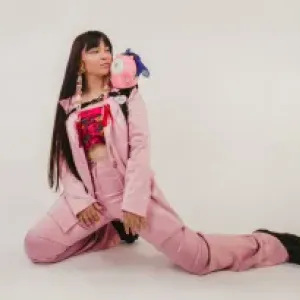 Danielle Boyer knelt on the floor with a craft project on her shoulder  