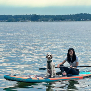 Dannie and her dog on a paddle board.