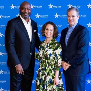 David L. Casey, Tapestry's Chief Diversity and Social Impact Officer; Kathy Roth-Douquet, Blue Star Families CEO; and Todd Kahn, COACH CEO standing in front of a blue backdrop