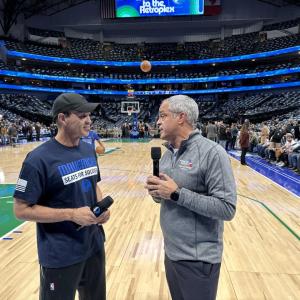 Two men talking on mics on the basketball court