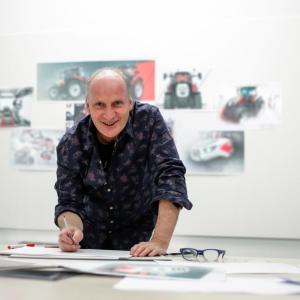 David Wilkie stood at a table writing on paper