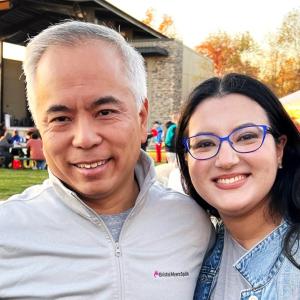 David Lin and Asalia Goldberg, others in a park setting behind them.