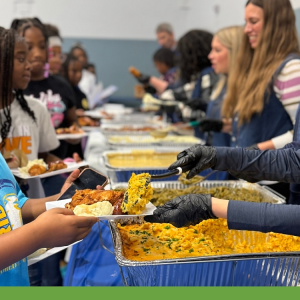 Children picking up plates of food at Day Of Dependability Dinner 