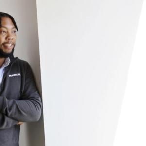 Demarcus Reaves looking out a window smiling