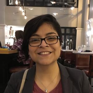 Denisse De la Cruz, sitting at restaurant 