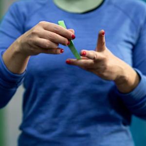 Alexandra Toth applying tape to her hands