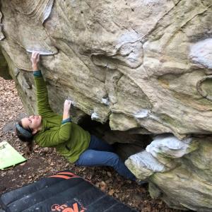 Alexandra Toth climbing a boulder