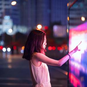 person touching large screen