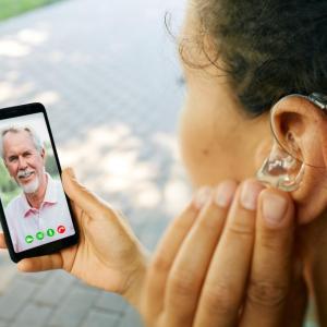 person with hearing aid talking on video call