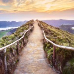 Artistic representation of a road leading off into a beautiful sunset with Discovery Education logo in the lower left corner