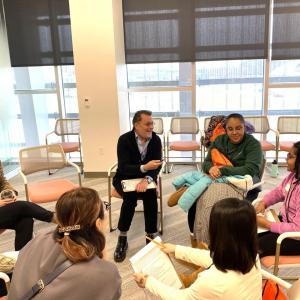 Group of people sitting on chairs in a circle