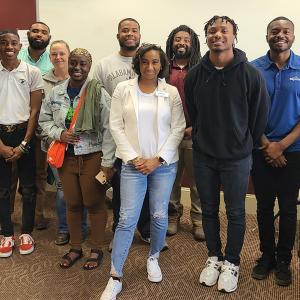 Ebony, center stood in the centre of a group of people