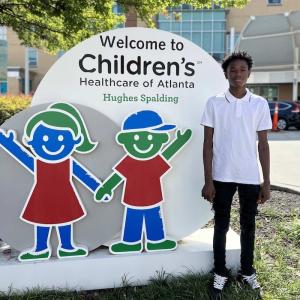 Learning to fly; Kordell shown in front of the Children's Healthcare of Atlanta.