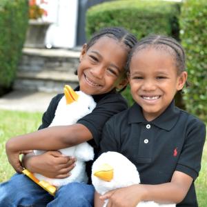 Young twins shown holding their My Special Aflac Ducks.