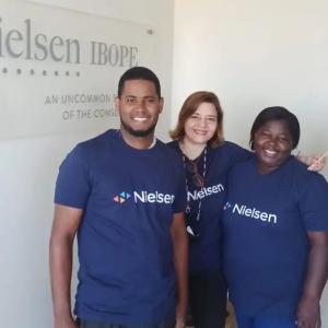 Three people, one holding Dominican flag