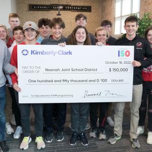 students holding a big check
