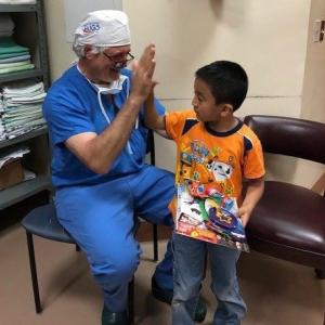 Doctor high fiving child
