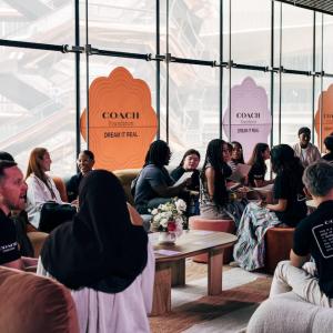 Large group sitting together at Coach Dream Day event