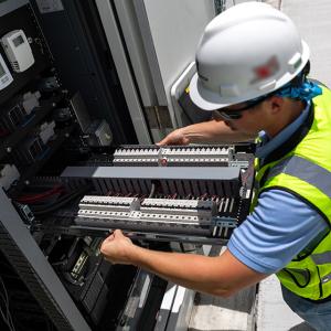 person working on electrical equipment