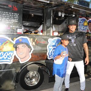 Kid and adult posing in front of Tai's Taco Truck