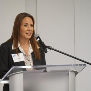 Woman speaking at a lectern