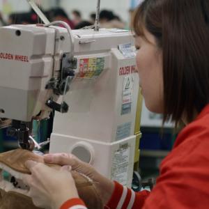 woman sewing boot at sewing machine