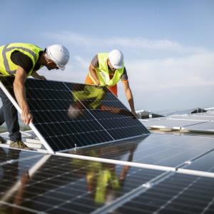 Workers installing solar panels.