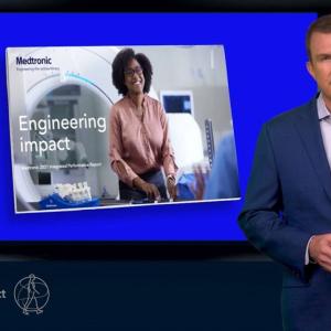 person presenting in front of television screen