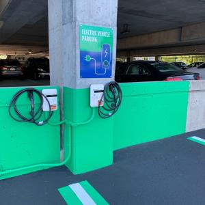 Electric vehicle charging station in a parking garage