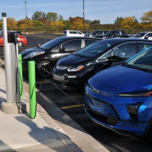 cars parked by EV charging stations