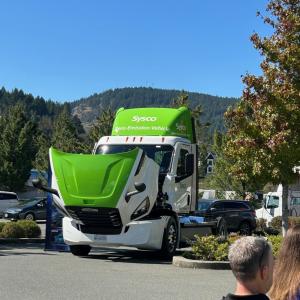 A Sysco semi truck with the hood open.
