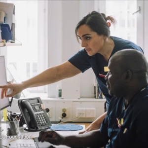 Health care workers consult their notes in a clinic. Photo by: The Bristol Myers Squibb Foundation