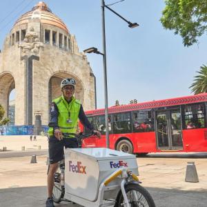 Person delivering for FedEx via bicycle