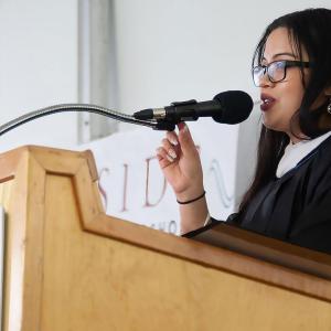 Student at Eastside College Preparatory School stood talking into a microphone