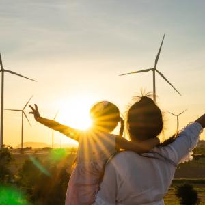 Man and a child watching a sunset.