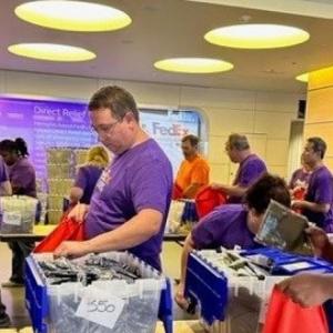 A group of people helping fill holiday care packages
