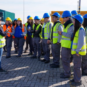 Students listing to an employee from DP World in San Antonio inside the port terminal