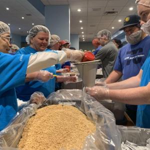 Elanco employees packing food